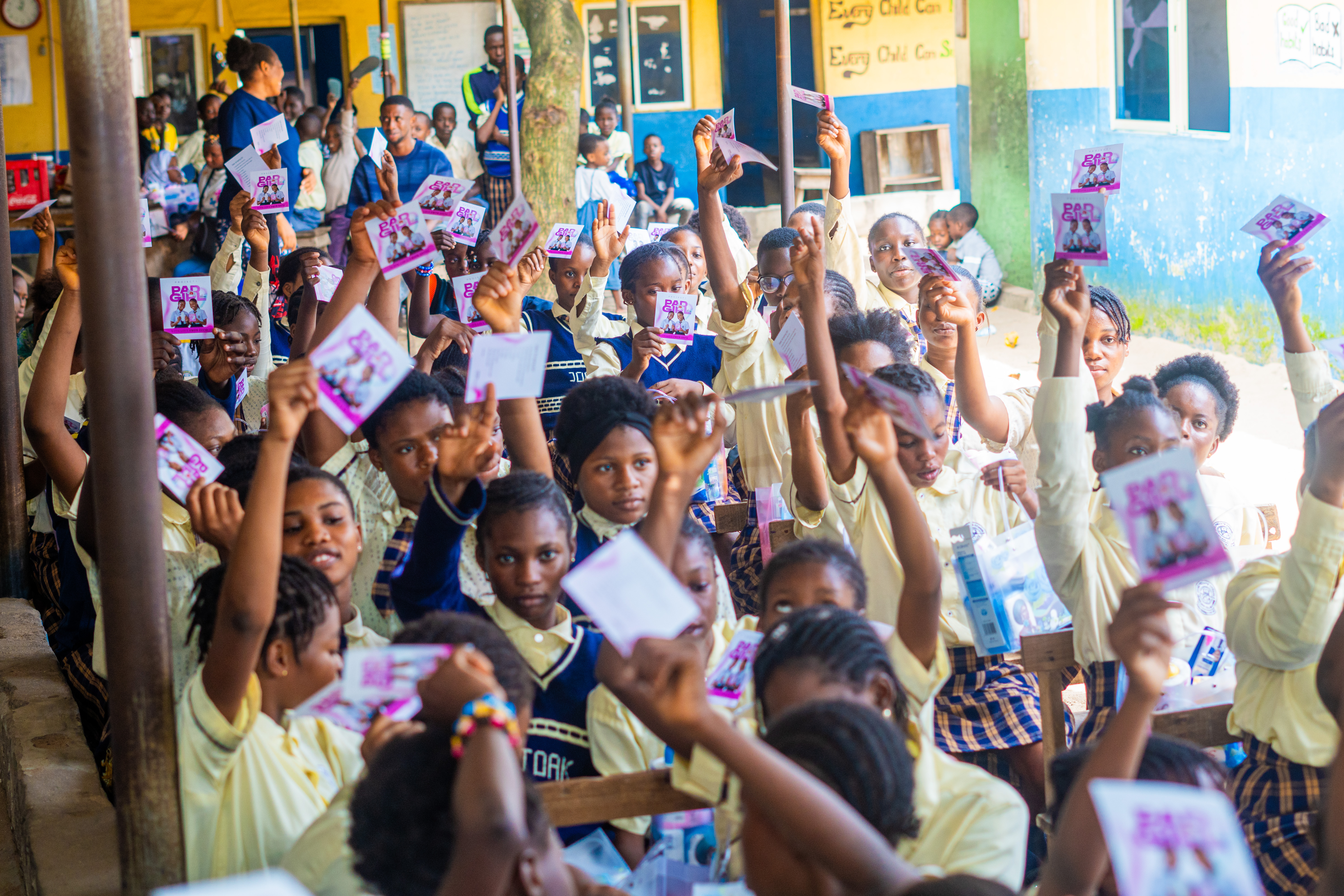 Schoolgirls holding their hygiene kits